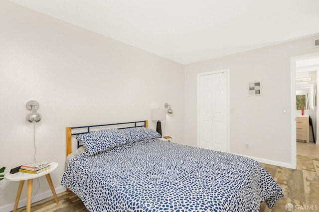 bedroom featuring wood-type flooring and a closet