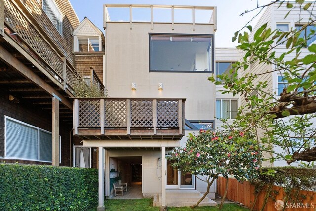 rear view of house featuring a patio area and fence