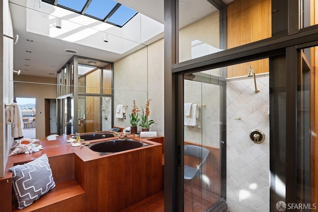 full bathroom with a skylight, a shower stall, visible vents, and vanity