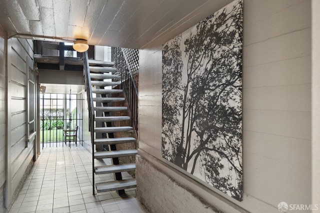 staircase featuring tile patterned flooring