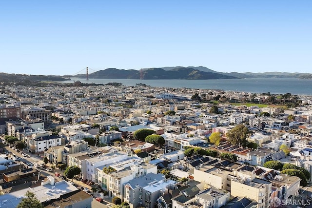 birds eye view of property with a view of city and a water and mountain view