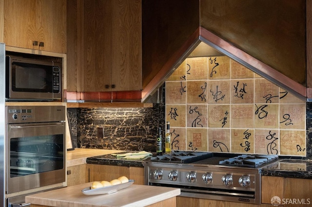 kitchen featuring range, stainless steel oven, and decorative backsplash