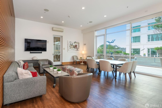 living room featuring a wall unit AC and dark hardwood / wood-style flooring