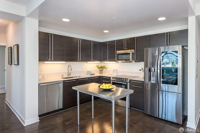 kitchen with dark brown cabinetry, stainless steel appliances, dark hardwood / wood-style floors, and sink