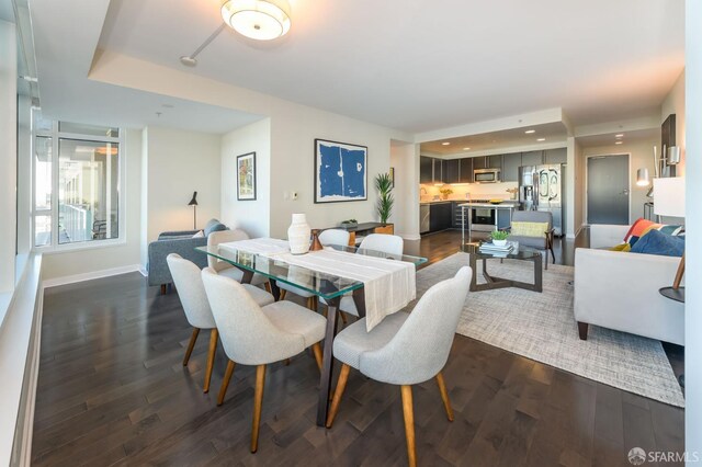 dining space with dark hardwood / wood-style floors