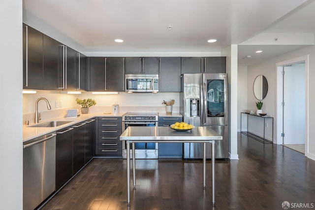 kitchen with sink, appliances with stainless steel finishes, and dark wood-type flooring