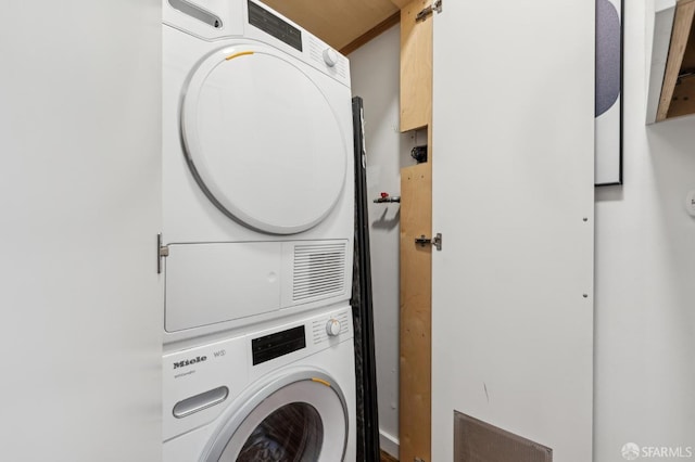 laundry area with laundry area and stacked washer and clothes dryer