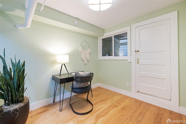 home office featuring wood finished floors and baseboards