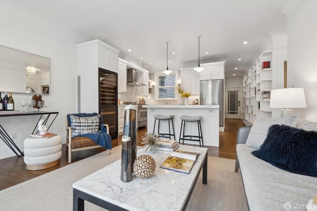 living area featuring light wood-type flooring and recessed lighting