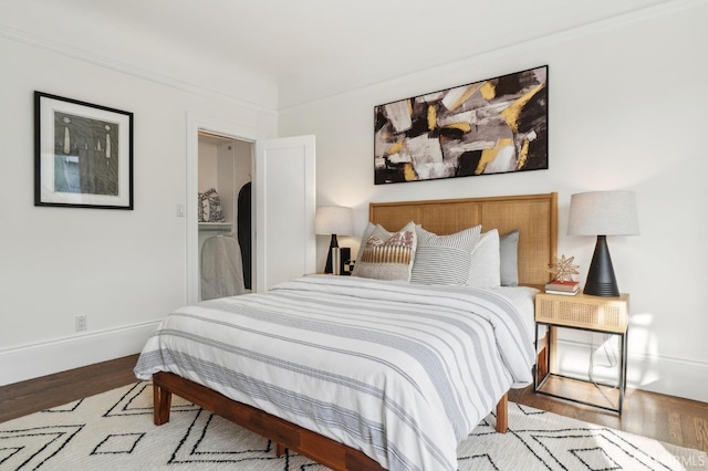 bedroom featuring baseboards and wood finished floors