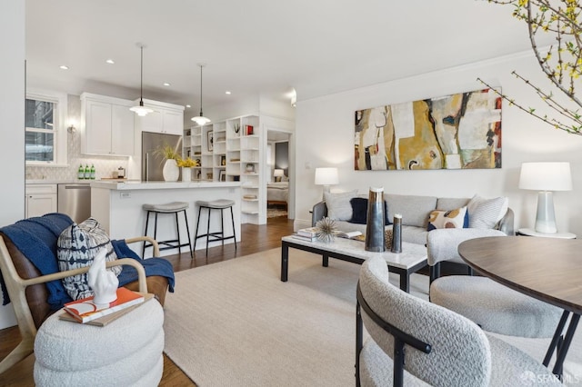 living area featuring wood finished floors and recessed lighting