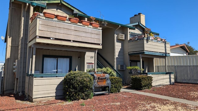 multi unit property featuring fence and a chimney