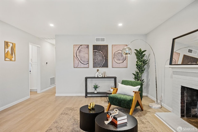 living area with a fireplace and hardwood / wood-style floors