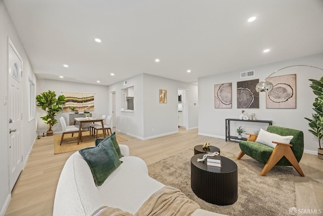 living room with light hardwood / wood-style flooring