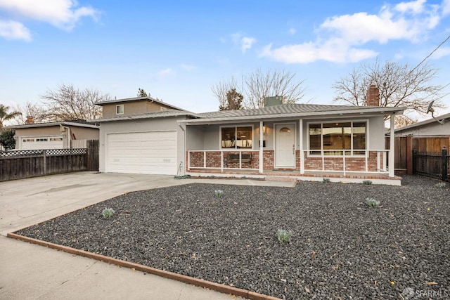 ranch-style home with covered porch and a garage