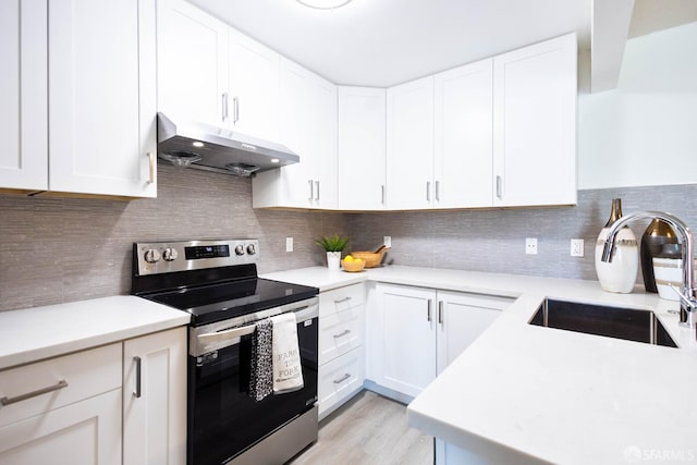 1360 9th Ave Unit 7, San Francisco, CA 94122 - kitchen with stainless steel range with electric stovetop, under cabinet range hood, and light countertops