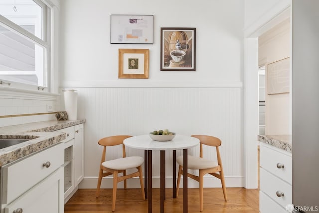 1205 Oak St Unit 2, San Francisco, CA 94117 - dining space with a wainscoted wall and light wood-type flooring