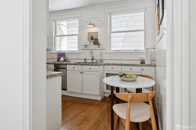 1205 Oak St Unit 2, San Francisco, CA 94117 - kitchen featuring dishwasher, white cabinetry, healthy amount of natural light, and wood finished floors