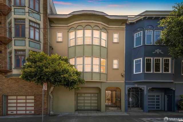 1205 Oak St Unit 2, San Francisco, CA 94117 - property at dusk with an attached garage