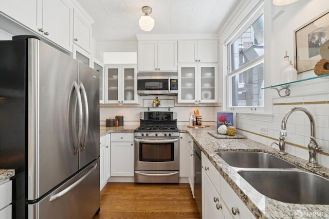 1205 Oak St Unit 2, San Francisco, CA 94117 - kitchen with appliances with stainless steel finishes, white cabinets, tasteful backsplash, and glass insert cabinets