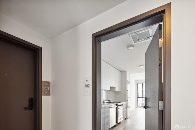 corridor featuring light hardwood / wood-style floors