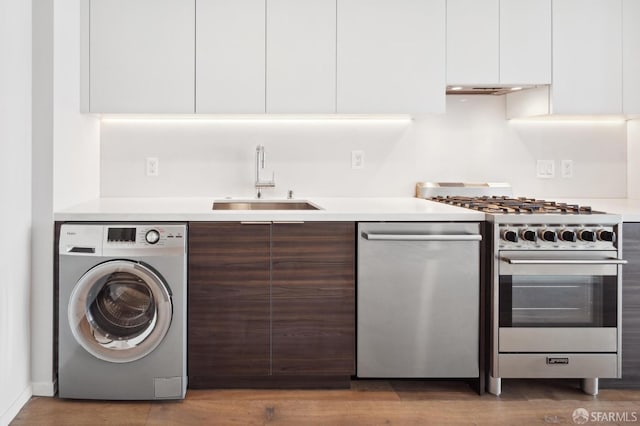 1433 Bush St Unit 702, San Francisco, CA 94109 - kitchen featuring washer / dryer, sink, white cabinetry, stainless steel appliances, and dark brown cabinetry