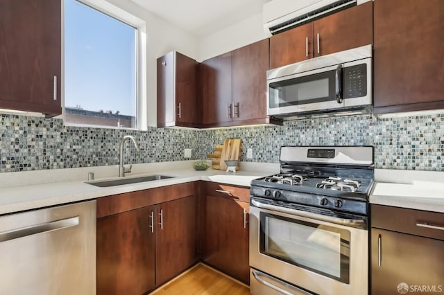 kitchen featuring appliances with stainless steel finishes, sink, and decorative backsplash