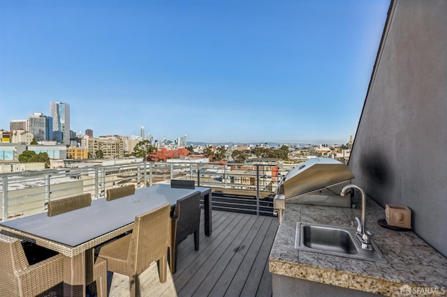 wooden terrace with sink and grilling area