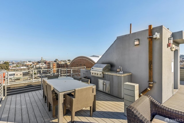 wooden deck featuring an outdoor kitchen, sink, and grilling area