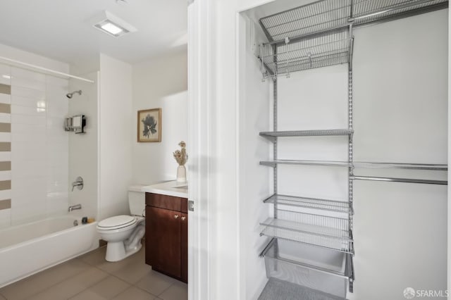 full bathroom with tile patterned flooring, vanity, toilet, and tiled shower / bath