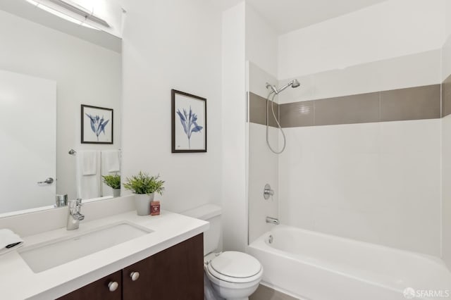 full bathroom with tiled shower / bath, vanity, and toilet