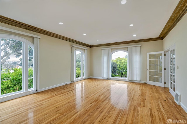 unfurnished living room with crown molding and light hardwood / wood-style floors