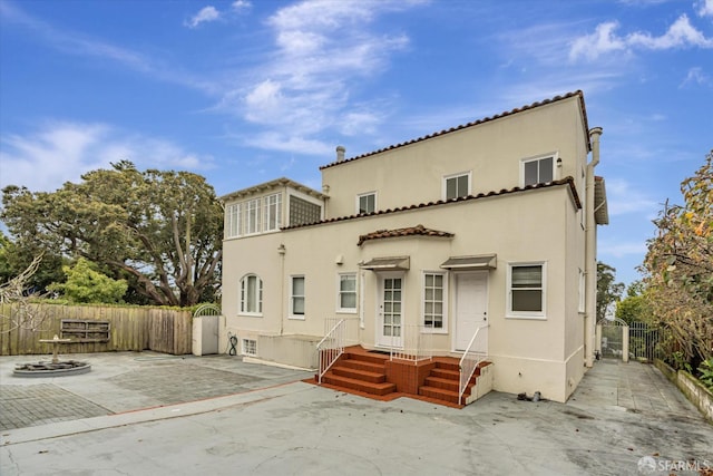 view of front of home with an outdoor fire pit and a patio