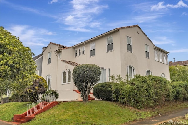 view of property exterior featuring a lawn