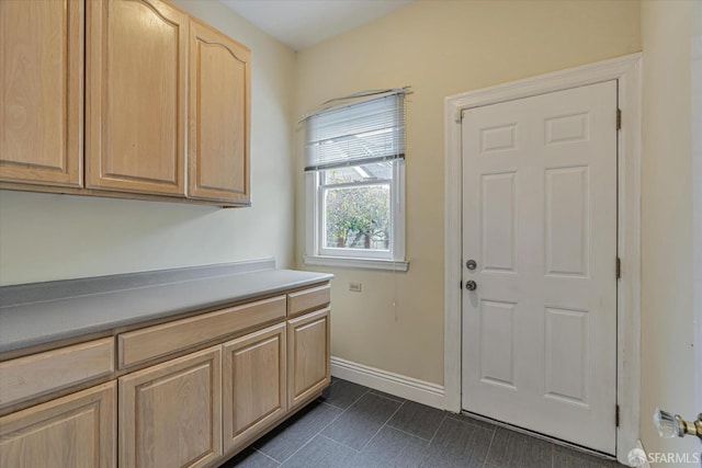 washroom with dark tile patterned flooring