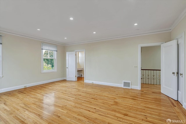 unfurnished bedroom featuring crown molding and light wood-type flooring