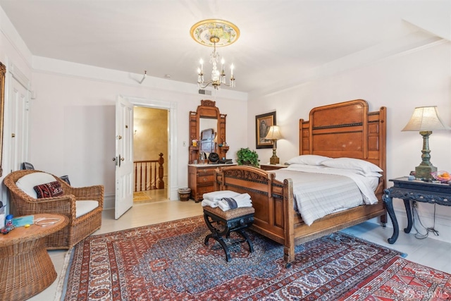 bedroom with wood finished floors, ornamental molding, and an inviting chandelier
