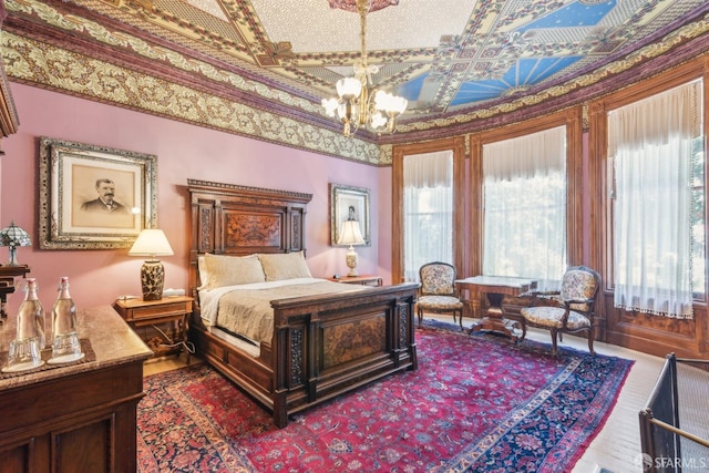 bedroom featuring an ornate ceiling and a notable chandelier