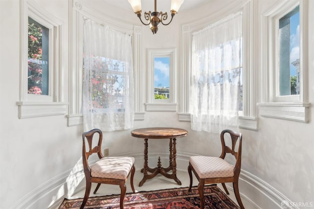 living area featuring a wealth of natural light and a chandelier