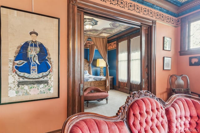 sitting room featuring carpet flooring and ornamental molding