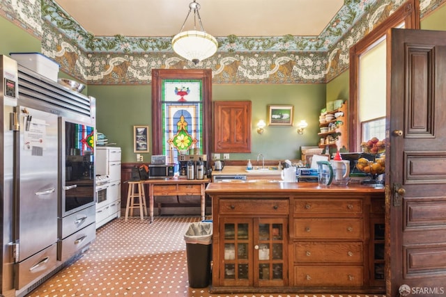 interior space with sink and decorative light fixtures