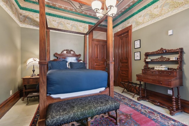 bedroom featuring baseboards, wood finished floors, and a notable chandelier