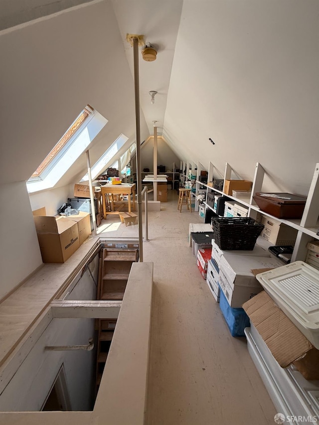 unfinished attic featuring a skylight