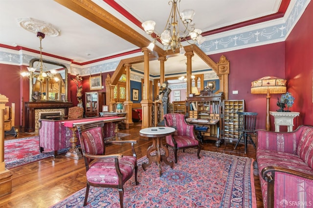 sitting room with crown molding, hardwood / wood-style flooring, and decorative columns