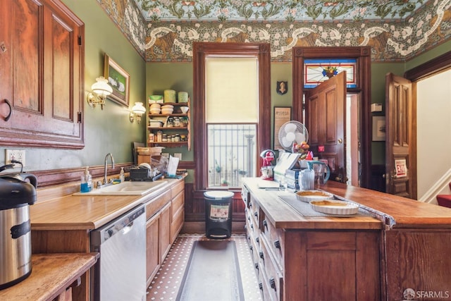 kitchen with stainless steel dishwasher and a sink