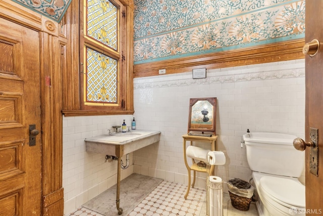 bathroom with tile walls and toilet