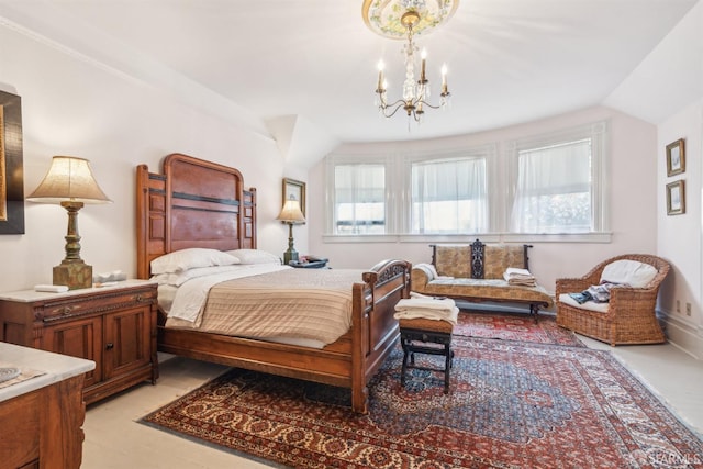 bedroom with lofted ceiling and an inviting chandelier