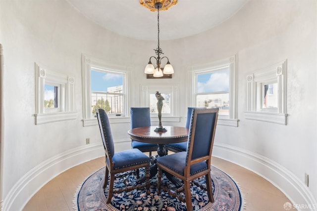 dining room featuring light wood-style flooring and a chandelier