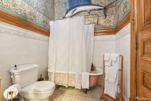 bathroom featuring toilet, tile walls, and tile patterned flooring