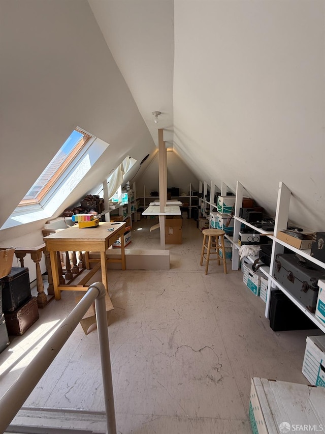 unfinished attic featuring a skylight